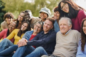 group of multiracial people with different ages having fun together at city park community and social gathering concept