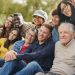 group of multiracial people with different ages having fun together at city park community and social gathering concept
