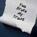 torn paper on dark blue background written you broke my trust means trust is broken when someone break expectations or promises made within relationship betrayal leading to emotional pain
