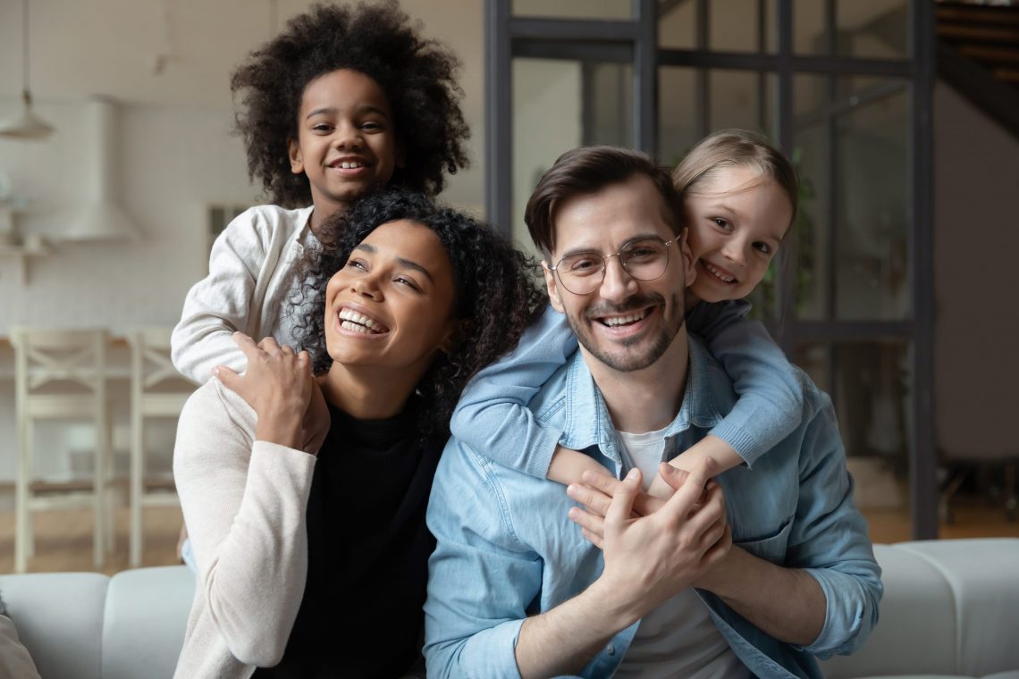 head shot portrait happy multiracial family looking at camera