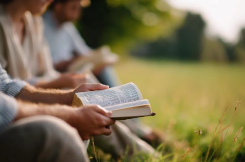 Deepening Spiritual Friendship Through Prayer and Scripture young group reading and discussing bible outdoors, christian fellowship and prayer meeting at park, outdoor scripture study, nature worship gathering, faceless participants, defocused