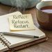open journal with pen and tea cup inspiring self reflection
