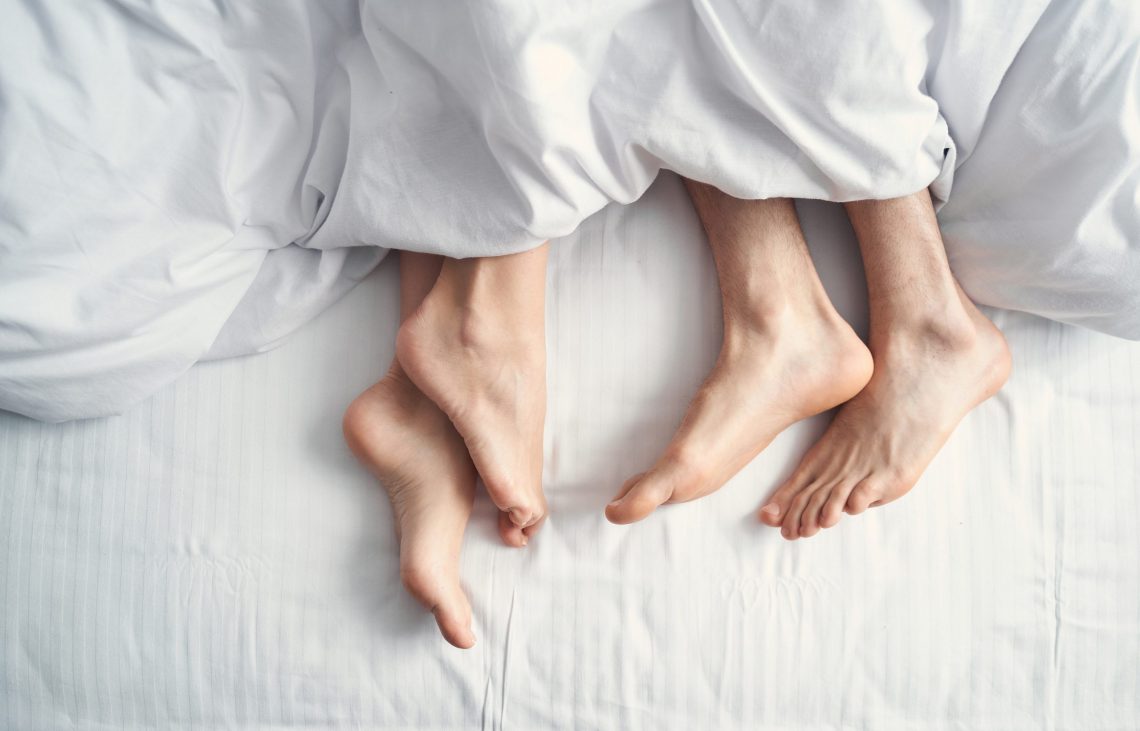 female and a man under the blanket