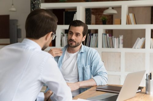 Shepherding Employees or Teams as a Christian Leader businesspeople male staff members talking sit at workplace desk