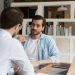 businesspeople male staff members talking sit at workplace desk